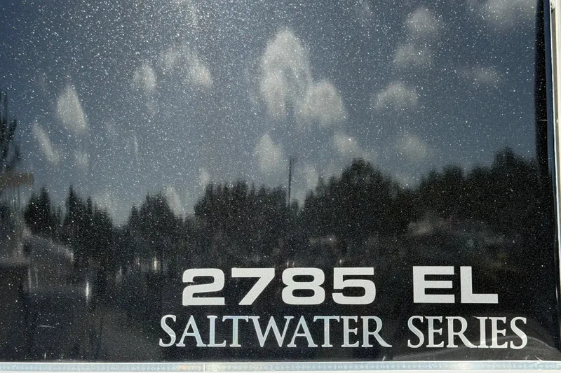 Slide: The Image of 2025 Avalon Excalibur LTD 2785 EL Saltwater Series boat, reflective surface with sky and clouds. - 96