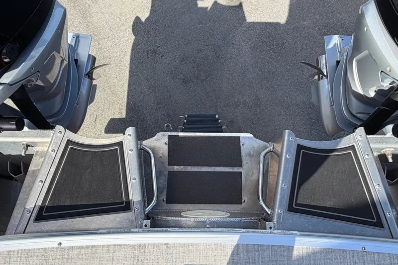 Slide: The Image of Rear view of 2025 Avalon Excalibur LTD Quad Lounge boat with dual engines. - 94