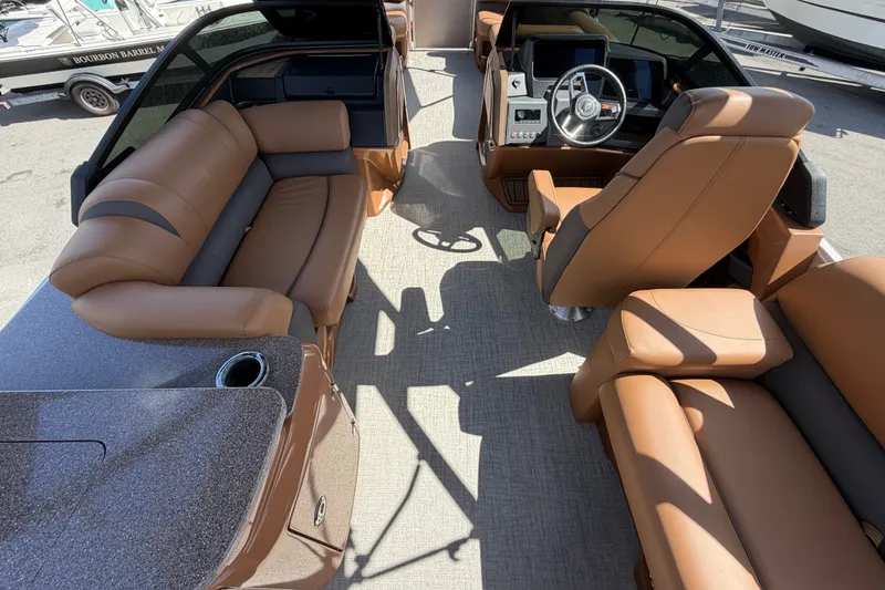 Slide: The Image of Luxurious interior of 2025 Avalon Excalibur LTD Quad Lounge boat with plush seating and modern dashboard. - 33