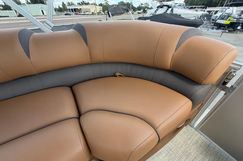 Slide: The Image of Luxurious seating on 2025 Avalon Excalibur LTD Quad Lounge boat, featuring tan and gray upholstery. - 58