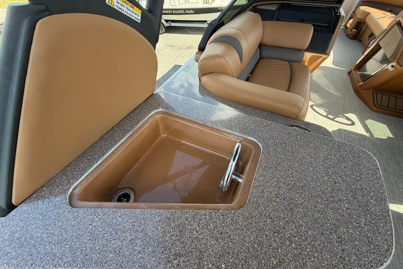 Slide: The Image of Luxurious interior of 2025 Avalon Excalibur LTD boat with sink and seating area. - 29