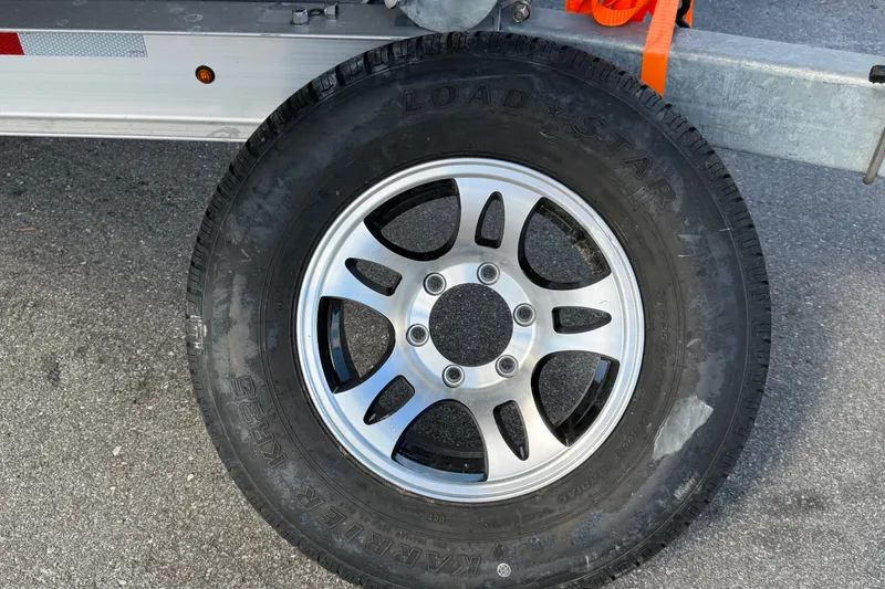 Slide: The Image of Close-up of a Load Star tire on a 2025 Avalon Excalibur LTD Quad Lounge. - 101