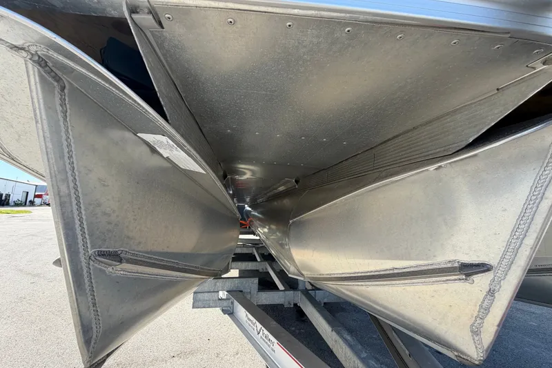 Slide: The Image of Underneath view of 2025 Avalon Excalibur LTD Quad Lounge pontoon boat on trailer. - 16