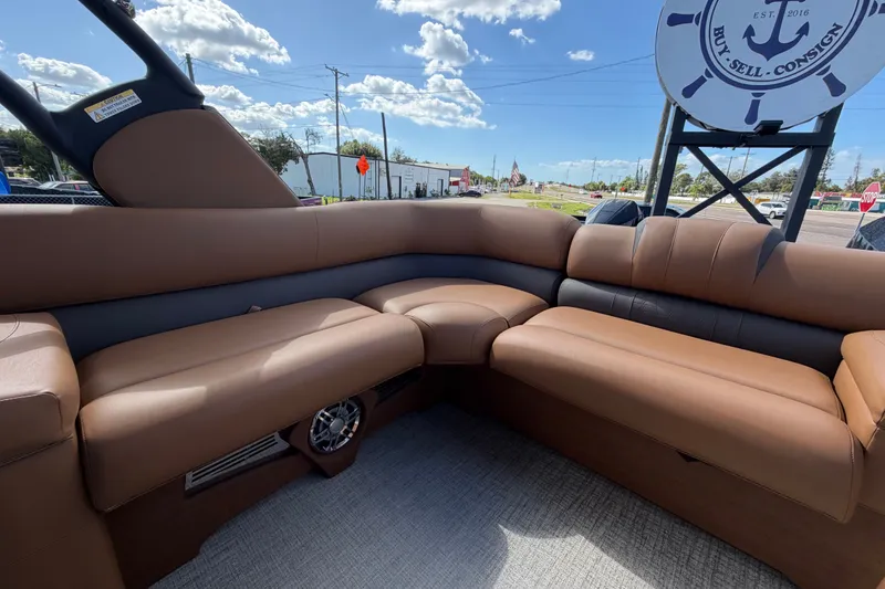 Slide: The Image of Luxurious seating on 2025 Avalon Excalibur LTD Quad Lounge boat, featuring brown upholstery. - 80
