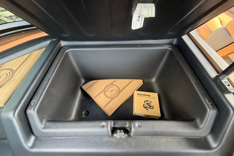Slide: The Image of Storage compartment of 2025 Avalon Excalibur LTD boat with AquaAmp box inside. - 41