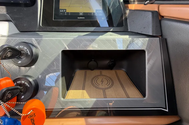 Slide: The Image of Dashboard of 2025 Avalon Excalibur LTD Quad Lounge with Garmin display and key switches. - 48