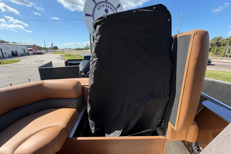 Slide: The Image of 2025 Avalon Excalibur LTD Quad Lounge boat interior with tan seating and black cover. - 87