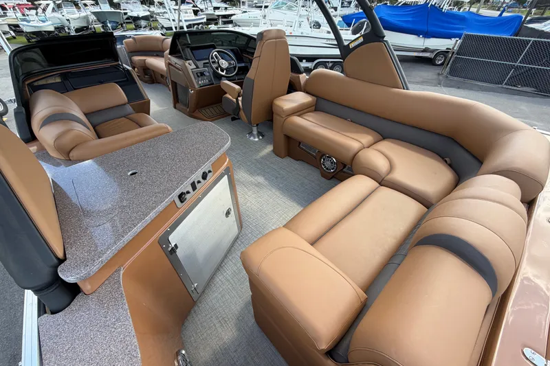 Slide: The Image of Luxurious interior of 2025 Avalon Excalibur LTD Quad Lounge boat with plush seating. - 23