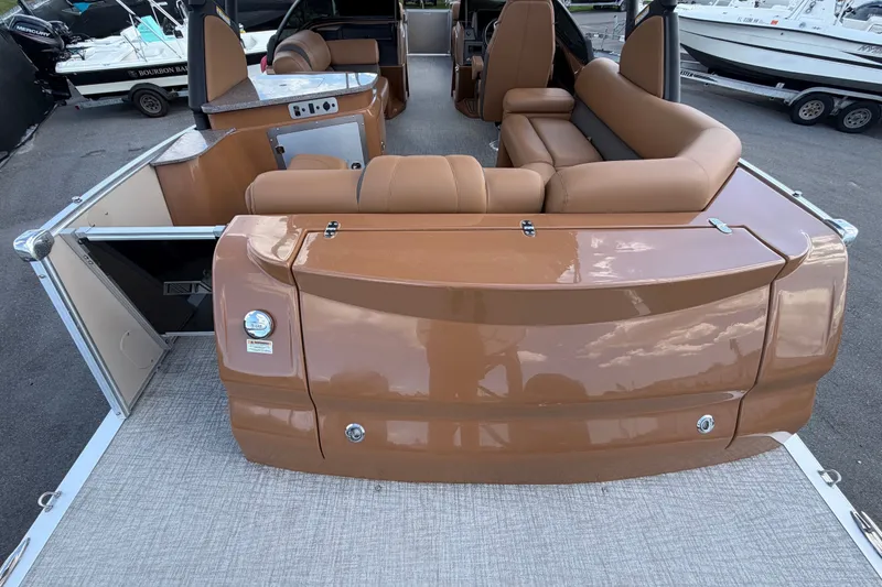 Slide: The Image of 2025 Avalon Excalibur LTD Quad Lounge boat with luxurious brown seating and modern design. - 18