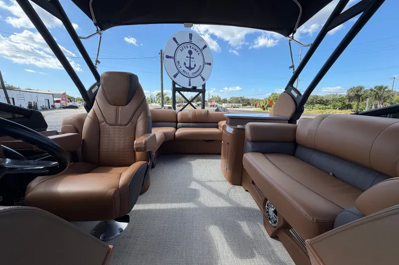 Slide: The Image of Luxurious interior of 2025 Avalon Excalibur LTD Quad Lounge boat with brown seating. - 75