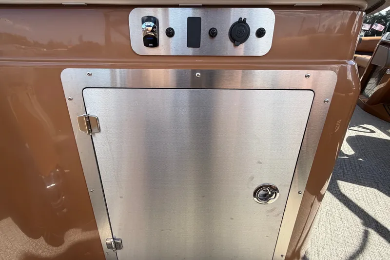 Slide: The Image of Control panel and storage compartment on 2025 Avalon Excalibur LTD Quad Lounge boat. - 25