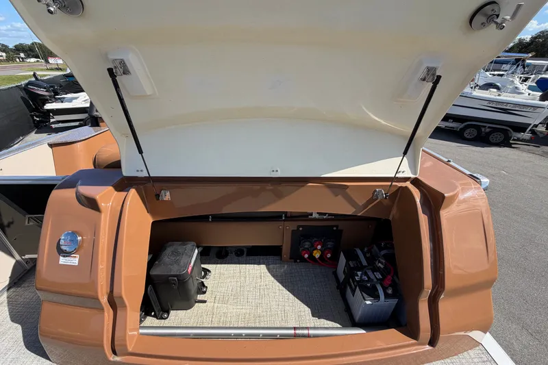 Slide: The Image of Open storage compartment of 2025 Avalon Excalibur LTD Quad Lounge boat. - 19