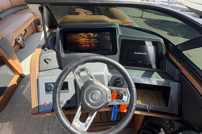 Slide: The Image of 2025 Avalon Excalibur LTD boat dashboard with Garmin display and luxurious seating. - 45