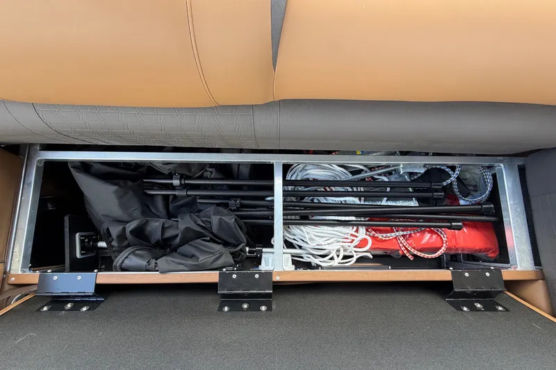 Slide: The Image of Storage compartment under a seat with ropes and equipment. - 61
