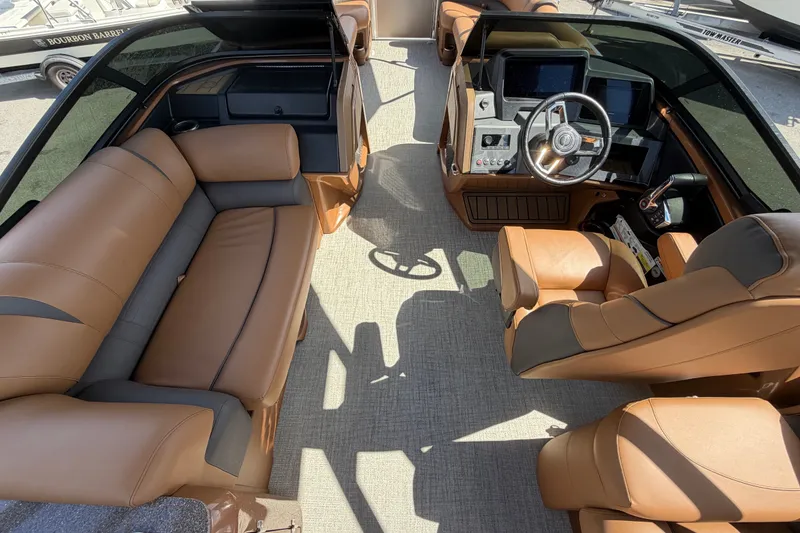Slide: The Image of 2025 Avalon Excalibur LTD Quad Lounge interior with luxurious tan seating and modern dashboard. - 35