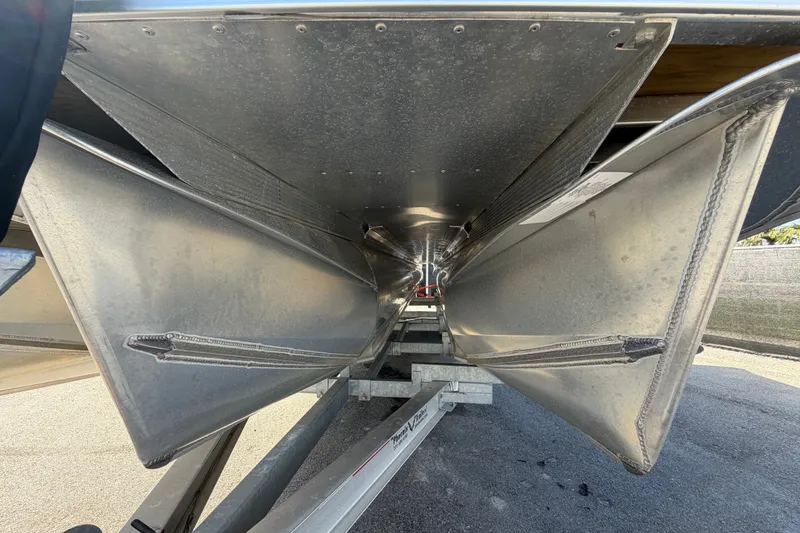 Slide: The Image of Underneath view of 2025 Avalon Excalibur LTD Quad Lounge pontoon boat on trailer. - 15
