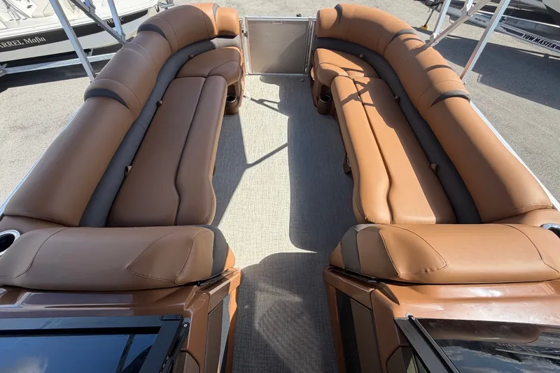Slide: The Image of Luxurious brown leather seating on a modern pontoon boat with a windshield. - 54