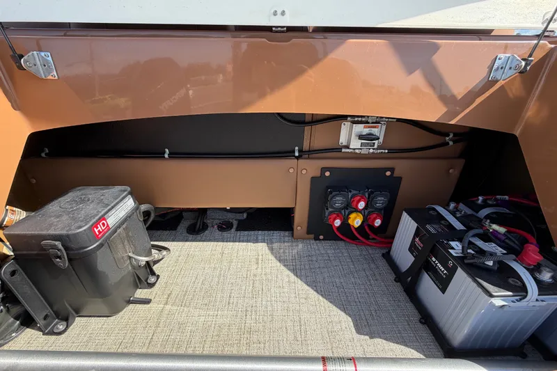 Slide: The Image of 2025 Avalon Excalibur LTD Quad Lounge Windshield boat battery compartment with wiring and components. - 20