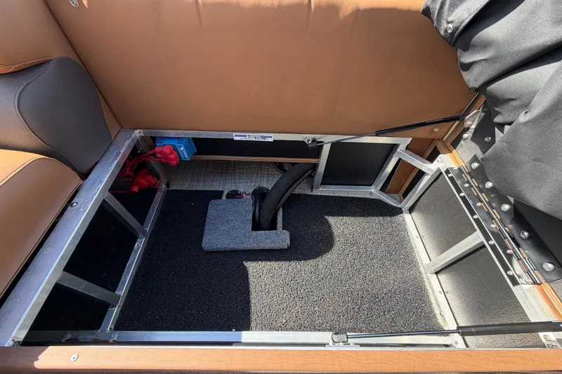 Slide: The Image of 2025 Avalon Excalibur LTD Quad Lounge storage compartment with brown seating and metal frame. - 88