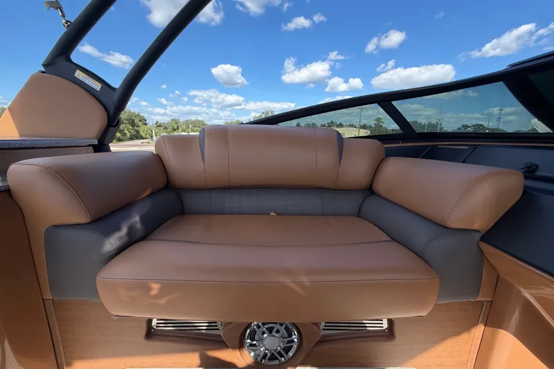Slide: The Image of Luxurious seating on 2025 Avalon Excalibur LTD Quad Lounge boat under a clear blue sky. - 36