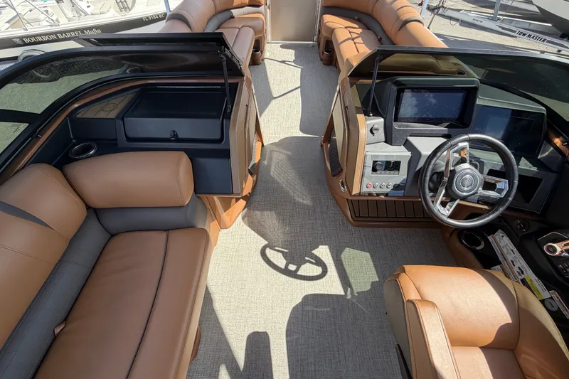Slide: The Image of Luxurious interior of 2025 Avalon Excalibur LTD Quad Lounge boat with modern dashboard and seating. - 39
