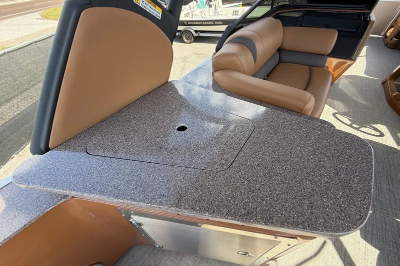 Slide: The Image of 2025 Avalon Excalibur LTD Quad Lounge interior with granite countertop and tan seating. - 28