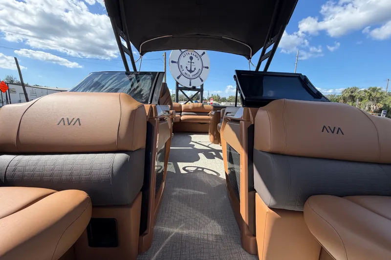 Slide: The Image of 2025 Avalon Excalibur LTD Quad Lounge boat interior with luxurious seating and windshield. - 70