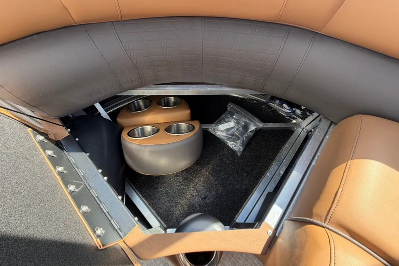 Slide: The Image of Close-up of a boat seat with brown and black upholstery and cup holders. - 63