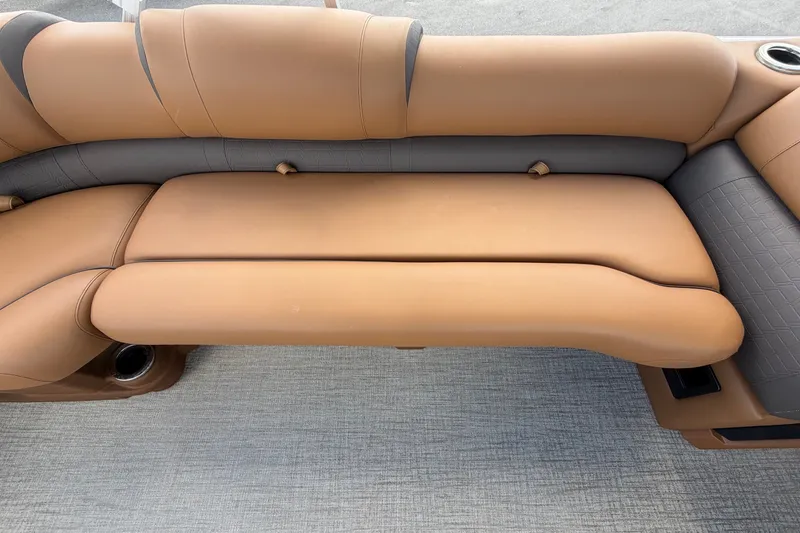 Slide: The Image of Luxurious beige upholstery on a boat seat with gray carpeting. - 60