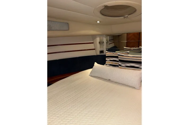 Slide: The Image of Interior cabin of a 1999 Azimut 52 yacht with cozy bedding and stylish decor. - 5