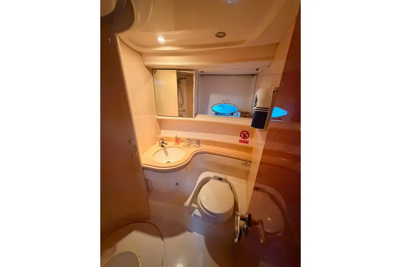 Slide: The Image of Bathroom interior of a 1999 Azimut 52 yacht, featuring sink and toilet. - 2