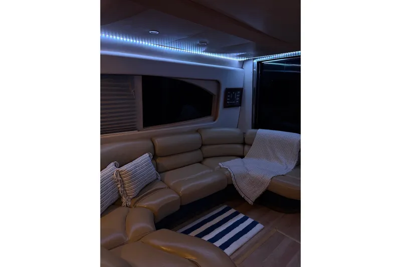 Slide: The Image of Luxurious interior of a 1999 Azimut 52 yacht with cozy seating and ambient lighting. - 4