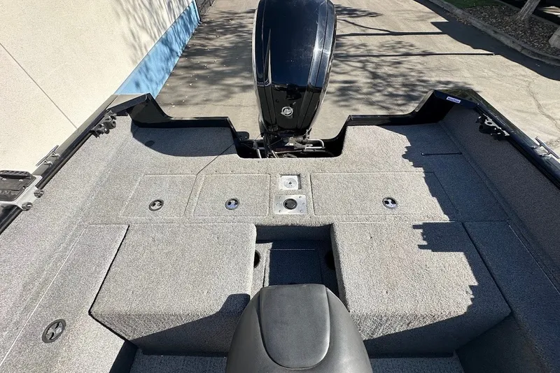 Slide: The Image of 2020 Tracker Pro Guide V-175 Combo boat interior with carpeted deck and motor. - 13