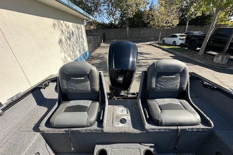 Slide: The Image of 2020 Tracker Pro Guide V-175 Combo boat interior with two seats and motor. - 14