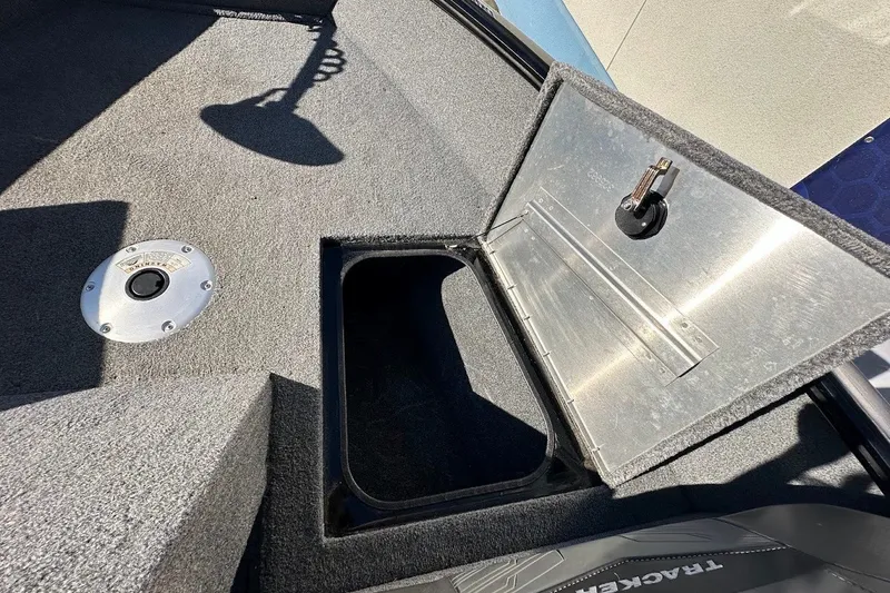 Slide: The Image of 2020 Tracker Pro Guide V-175 Combo boat storage compartment with open hatch and carpeted interior. - 39