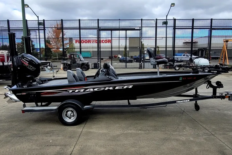 The Image of 2019 Tracker Pro Team 190 TX boat on trailer, parked outdoors. - 0