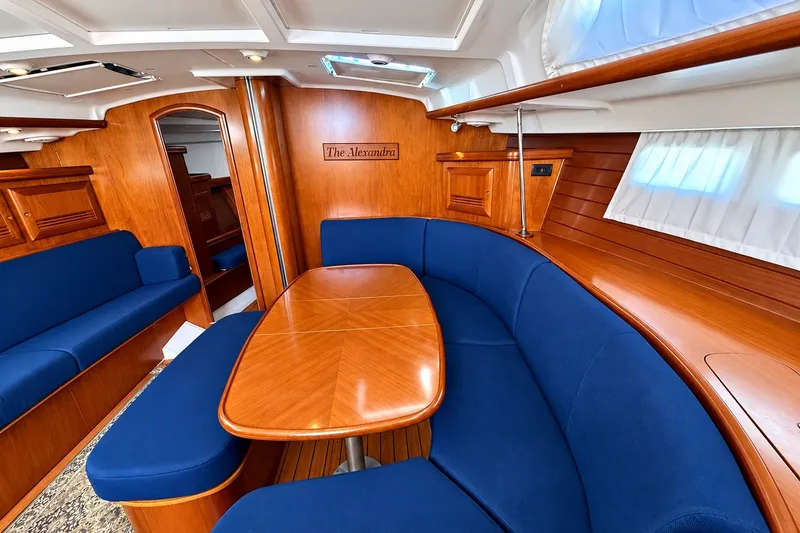Slide: The Image of Luxurious interior of 2005 Beneteau Oceanis 473 yacht with elegant wood finish and blue seating. - 21