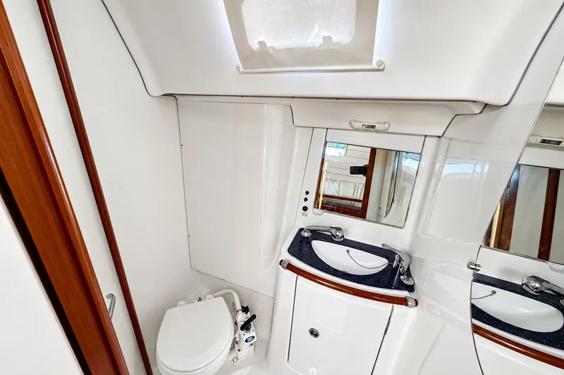 Slide: The Image of 2005 Beneteau Oceanis 473 yacht bathroom with sink, mirror, and toilet. - 37