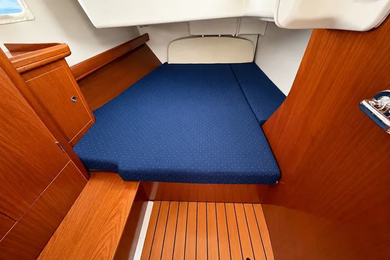 Slide: The Image of Interior cabin of 2005 Beneteau Oceanis 473 with blue mattress and wooden finish. - 35