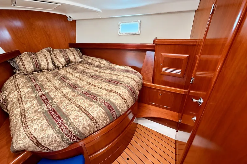 Slide: The Image of Luxurious cabin interior of 2005 Beneteau Oceanis 473 yacht with wood finish and cozy bedding. - 29