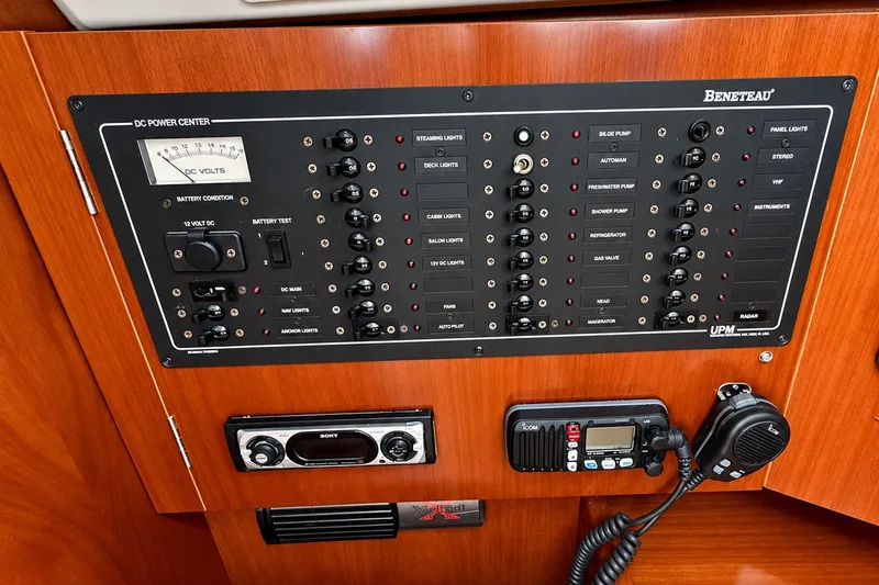 Slide: The Image of Control panel of a 2005 Beneteau Oceanis 473 yacht with various switches and gauges. - 25
