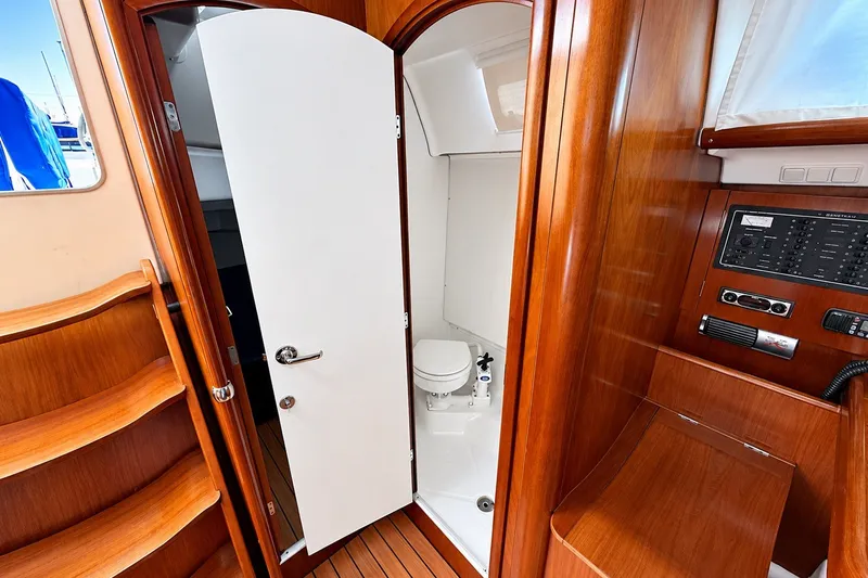 Slide: The Image of Interior of 2005 Beneteau Oceanis 473 yacht showing wooden cabinetry and compact bathroom. - 36