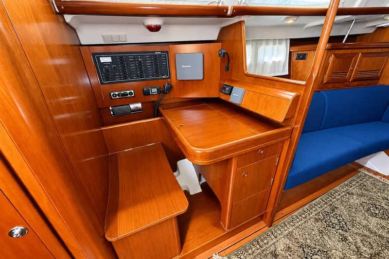 Slide: The Image of 2005 Beneteau Oceanis 473 yacht interior with navigation station and wooden cabinetry. - 24