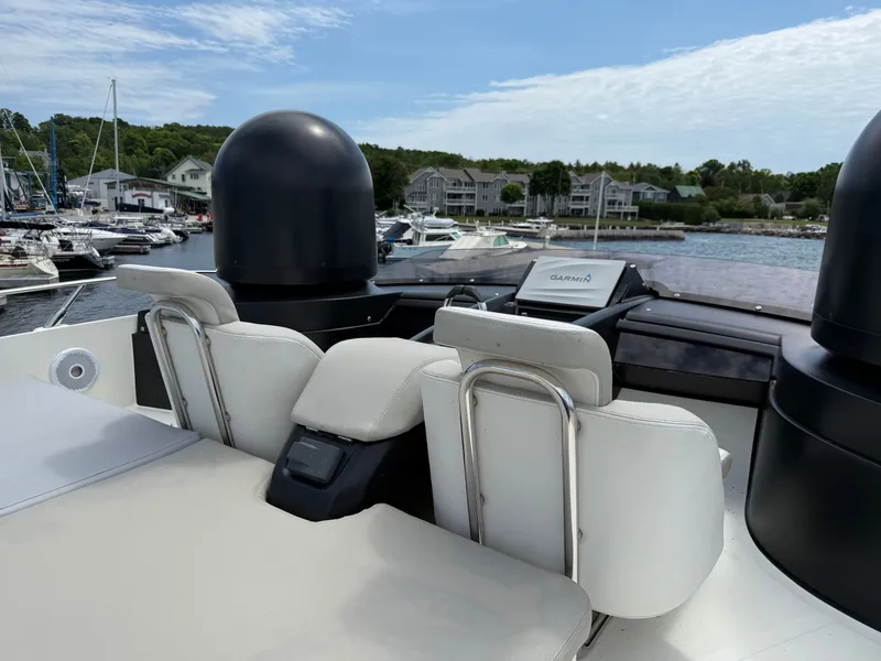 Slide: The Image of The image shows the helm of a 2019 Cranchi E 52S Evoluzione in a marina. - 23