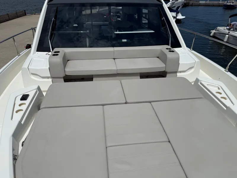 Slide: The Image of The image shows the deck of a 2019 Cranchi E 52S Evoluzione with gray cushions. - 19