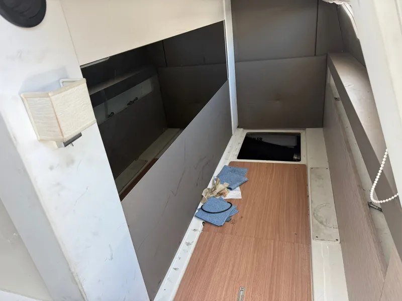 Slide: The Image of Interior of a 2019 Cranchi E 52S Evoluzione with wooden flooring and storage space. - 15