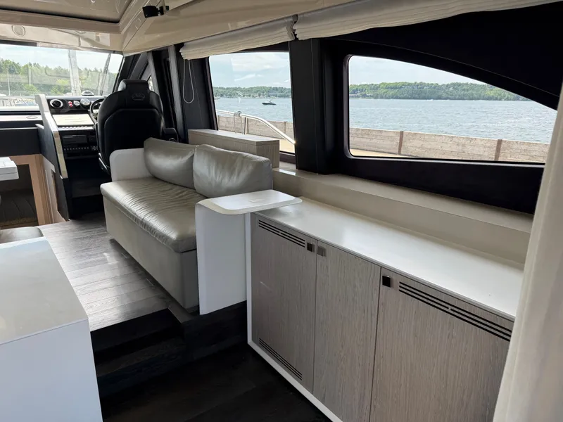 Slide: The Image of Interior of the 2019 Cranchi E 52S Evoluzione with a sofa and water view. - 25