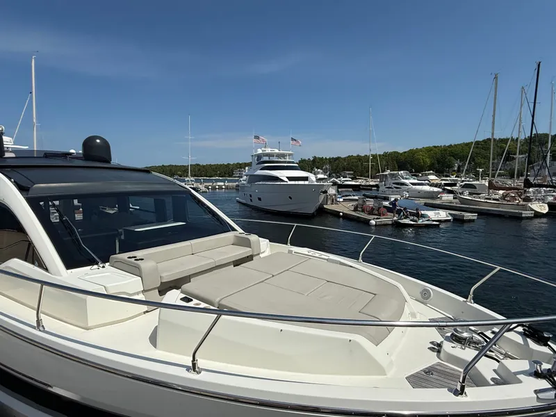 Slide: The Image of The 2019 Cranchi E 52S Evoluzione is docked in a busy marina with other boats. - 16