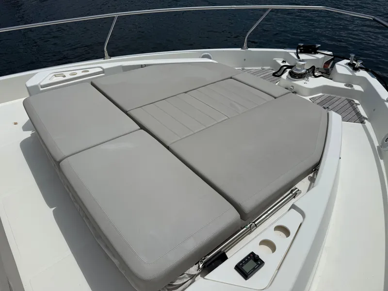 Slide: The Image of The image shows the sun deck of a 2019 Cranchi E 52S Evoluzione with gray cushions. - 18