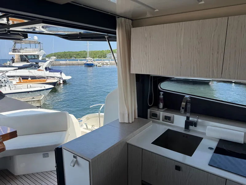 Slide: The Image of Interior of the 2019 Cranchi E 52S Evoluzione with a view of the marina. - 30